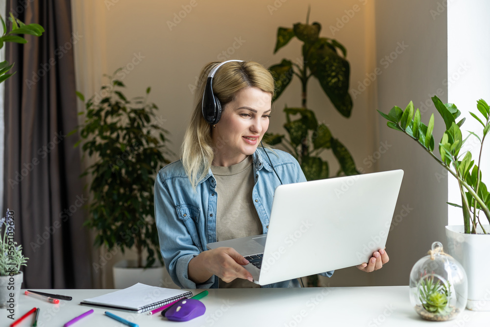 Pretty female student with cute smile keyboarding something on net-book while relaxing after lectures in University, beautiful happy woman working on laptop computer Pretty female student with cute smile keyboarding something on net-book while relaxing after lectures in University, beautiful happy woman working on laptop computer