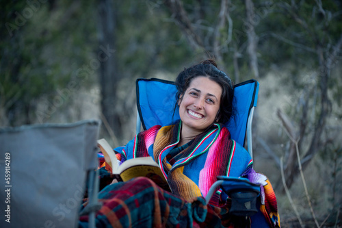 Portrait of woman sitting with book, New Mexico, USA photo