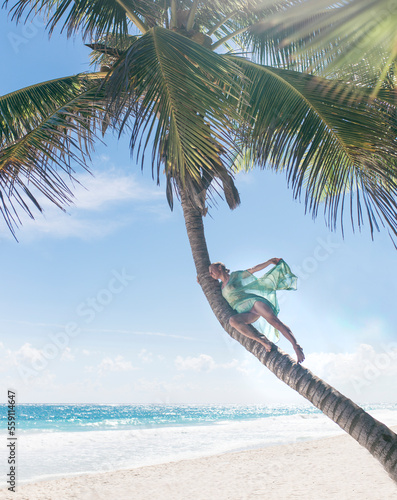 Fashionable Woman posing with caftan in palm tree