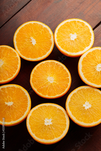 Orange halves on a wooden table. Orange slices close-up