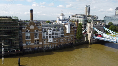 Old Warehouse converted into appartments overlooking Tower bridge in London UK drone aerial view