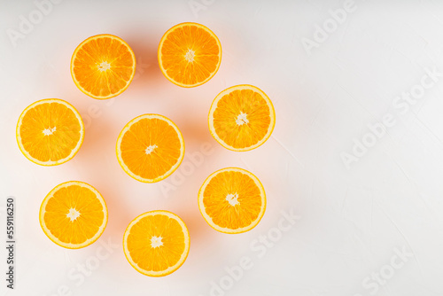 Fresh ripe oranges on a white background. Halves of juicy oranges for vegan