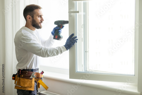 Canvas Print service man installing window with screwdriver