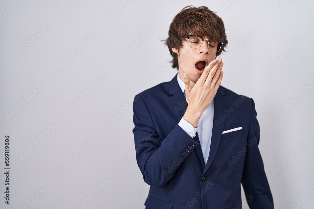 Hispanic business young man wearing glasses bored yawning tired covering mouth with hand. restless and sleepiness. Hispanic business young man wearing glasses bored yawning tired covering mouth with hand. restless and sleepiness.