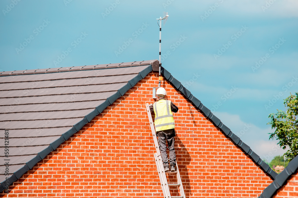 Construction site builder climbing on the ladder on working on hight Construction site builder climbing on the ladder on working on hight