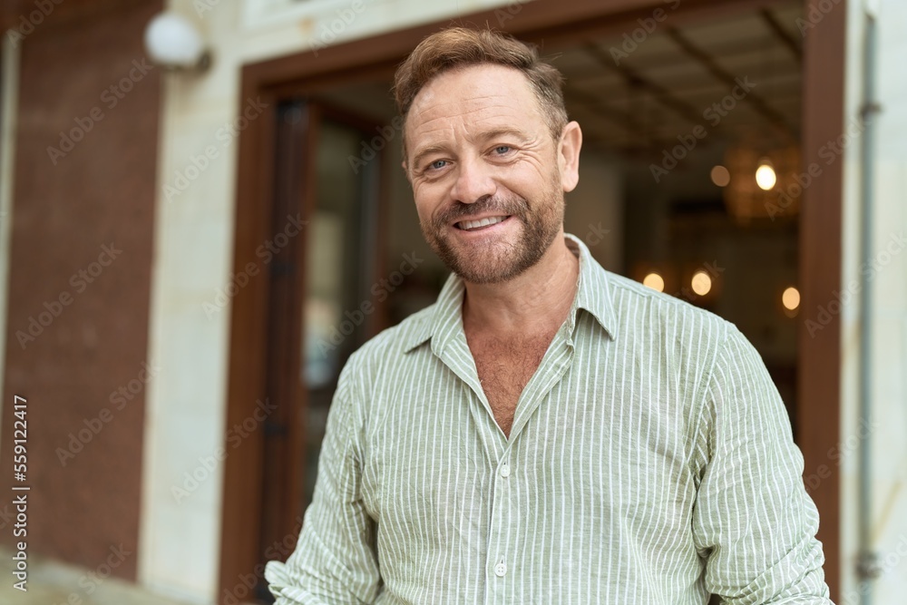 Middle age man smiling confident standing at street Middle age man smiling confident standing at street