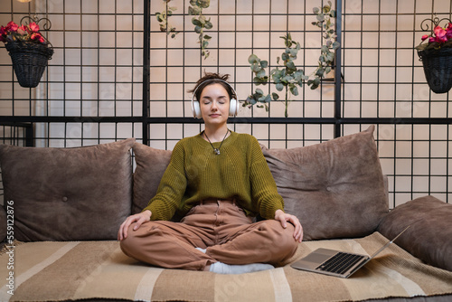 one woman doing guided meditation yoga self care practice at home