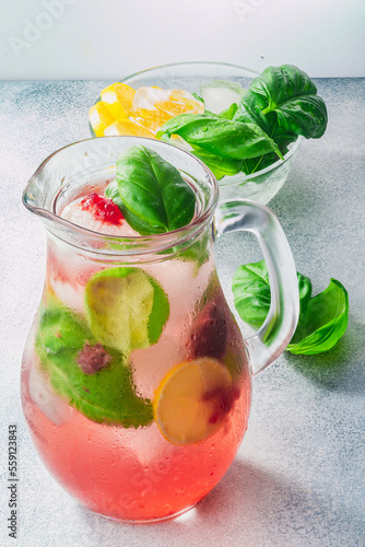 Strawberry basil lemonade iced jug pitcher over grey backdrop