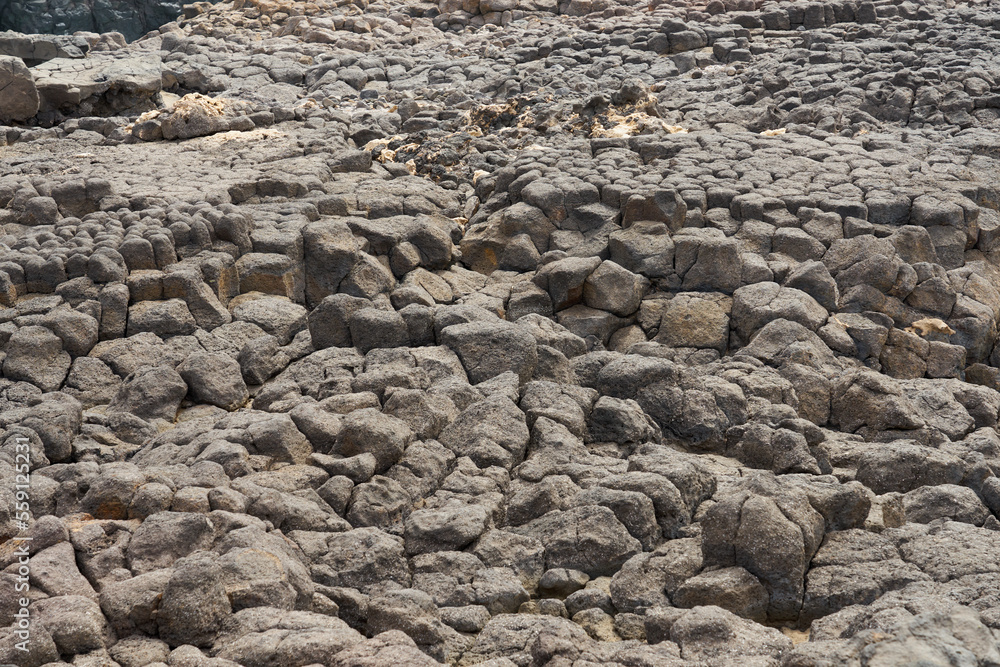 A stone volcanic backdrop on the coast of the island of Sal in Cape Verde.