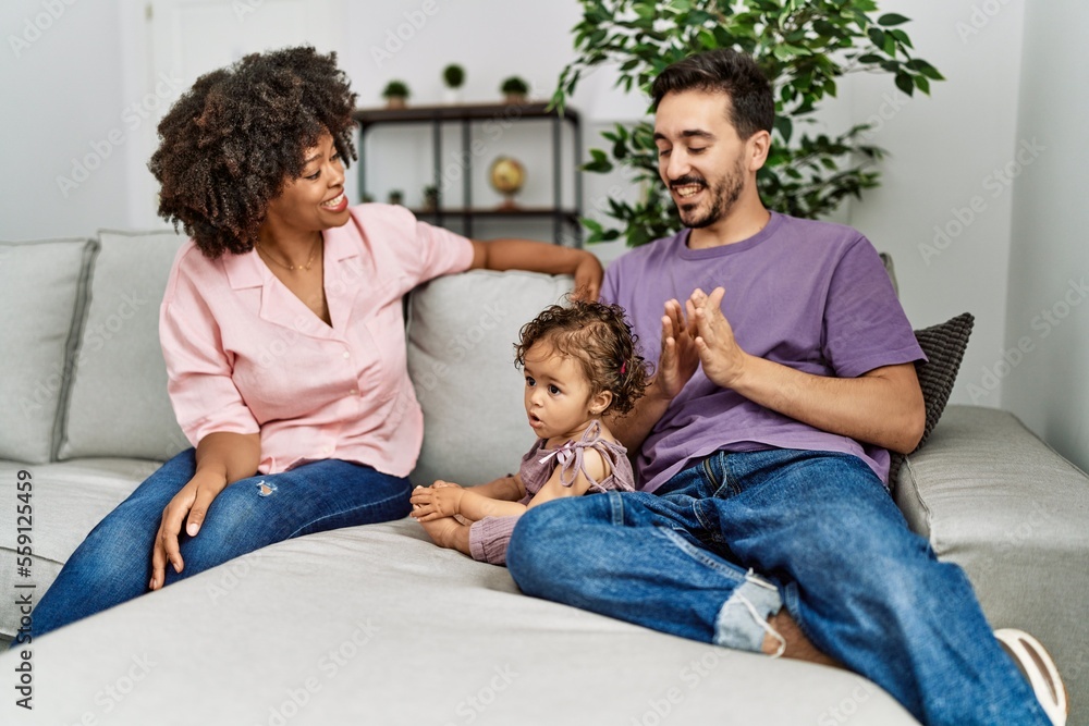 Couple and daughter smiling confident sitting on sofa at home Couple and daughter smiling confident sitting on sofa at home