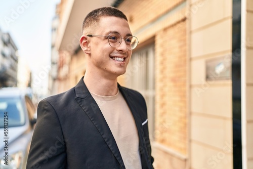 Young hispanic man executive smiling confident standing at street