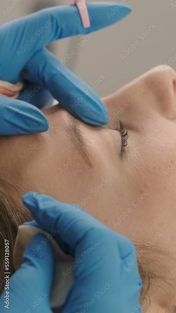 Professional tattooing eyebrow to a client Professional tattooing eyebrow to a client