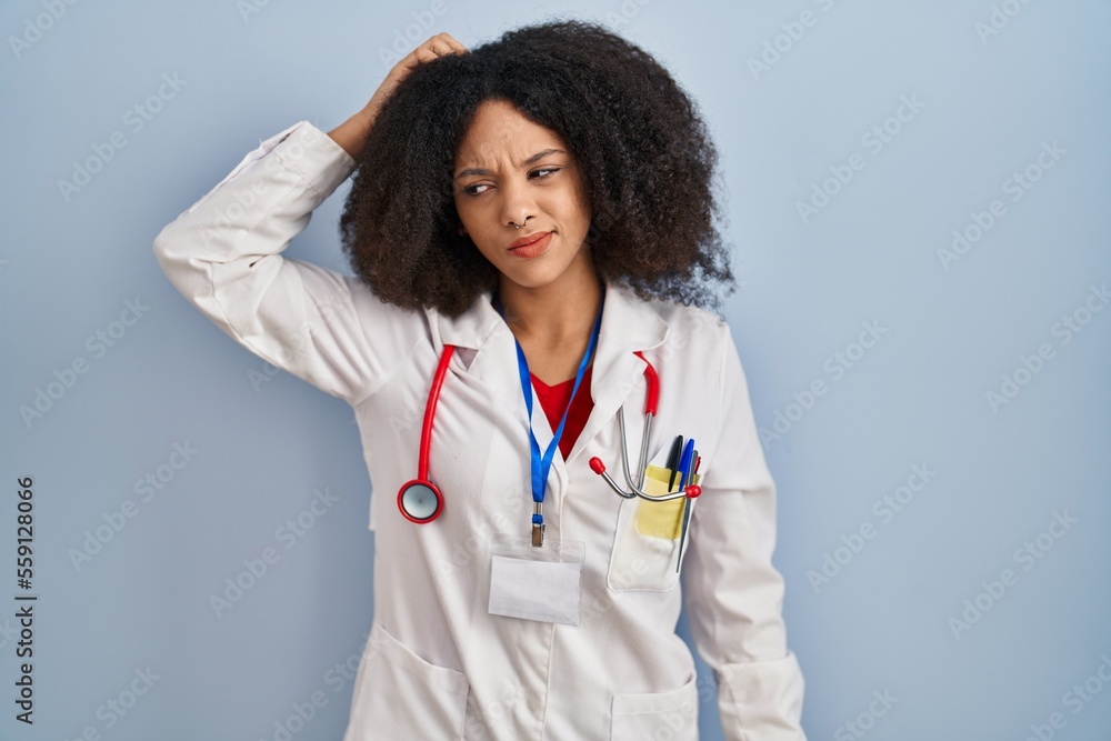 Young african american woman wearing doctor uniform and stethoscope confuse and wondering about question. uncertain with doubt, thinking with hand on head. pensive concept. Young african american woman wearing doctor uniform and stethoscope confuse and wondering about question. uncertain with doubt, thinking with hand on head. pensive concept.