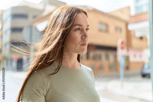 Young beautiful woman looking to the side with serious expression at street Free Download Young beautiful woman looking to the side with serious expression at street - GFXLoad