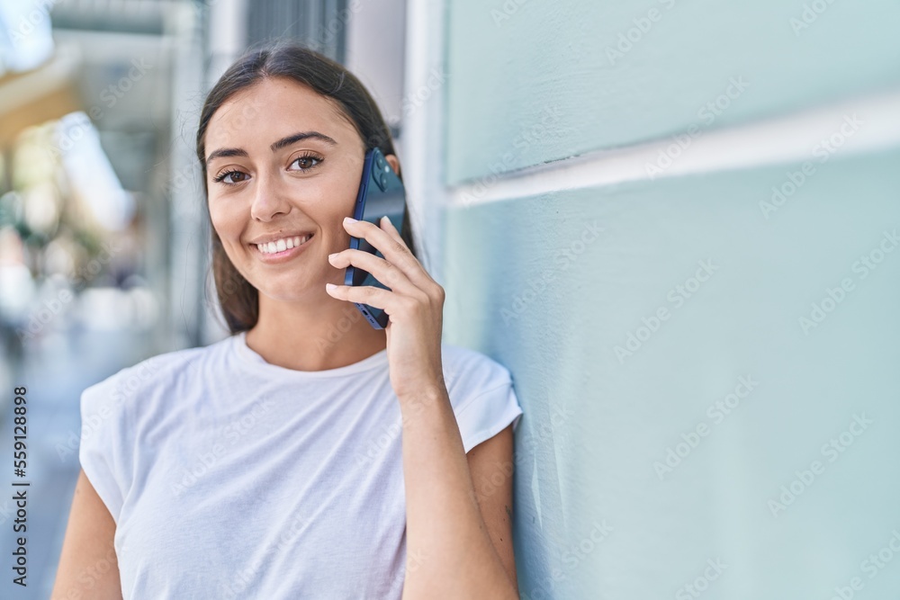 Young beautiful hispanic woman smiling confident talking on the smartphone at street Young beautiful hispanic woman smiling confident talking on the smartphone at street