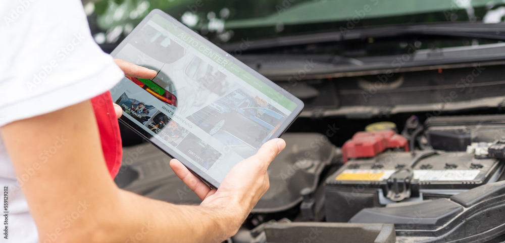 Close-up Of A Car Mechanic Using Digital Tablet. Close-up Of A Car Mechanic Using Digital Tablet.