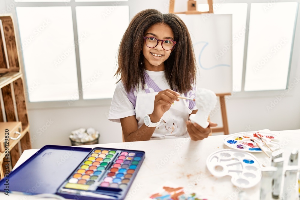 Fototapeta premium African american girl smiling confident drawing sculpture at art school