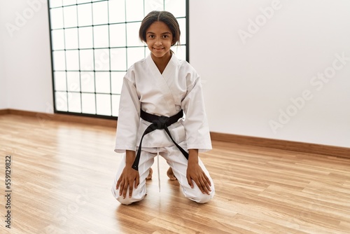 Tableau sur toile African american girl wearing kimono training karate at sport center
