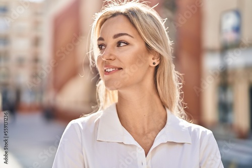 Wallpaper Mural Young blonde woman smiling confident standing at street Torontodigital.ca