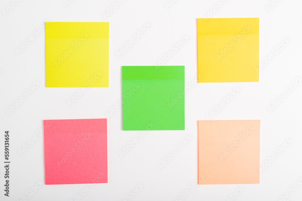 Five self-adhesive multi-colored stickers reminder mockup on a white surface Five self-adhesive multi-colored stickers reminder mockup on a white surface