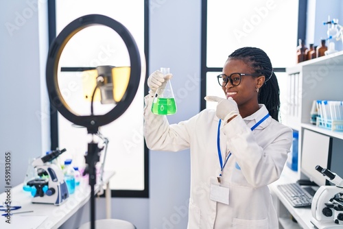 Tablou canvas African woman with braids working at scientist laboratory doing tutorial with sm