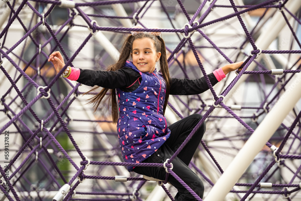 Cute teenage girl in the rope labyrinth kid park attraction Stock Photo ...