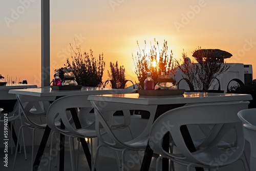 Restaurant in the foreground in silhouette in Santorini, Greece photo