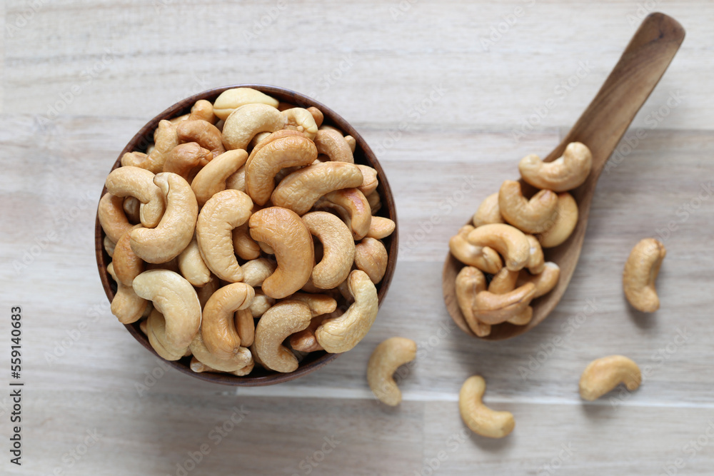 Top view of Roasted cashew nuts in a bowl on wooder background, Healthy eating concept Top view of Roasted cashew nuts in a bowl on wooder background, Healthy eating concept