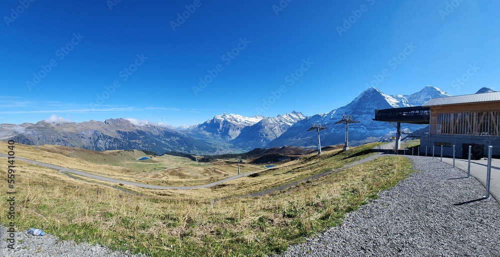 Panoramic view of snow mountain with rocky path and blue sky