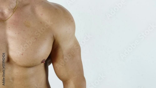 Fit, athletic muscular man pinching his arm skin