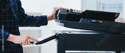 Quadro em tela Copier printer, Close up hand office man press copy button on panel to using the copier or photocopier machine for scanning document printing a sheet paper