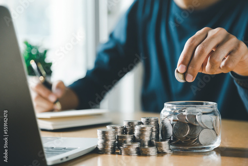 Man hands putting coins stack, Concept business finance saving money and investment.