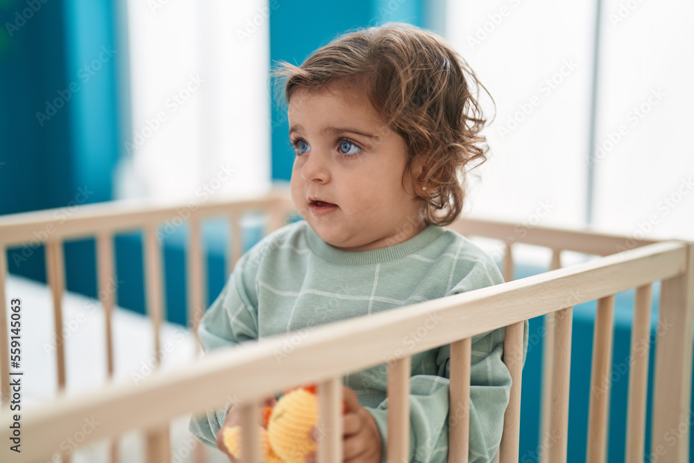 Adorable hispanic girl standing on cradle at bedroom Adorable hispanic girl standing on cradle at bedroom
