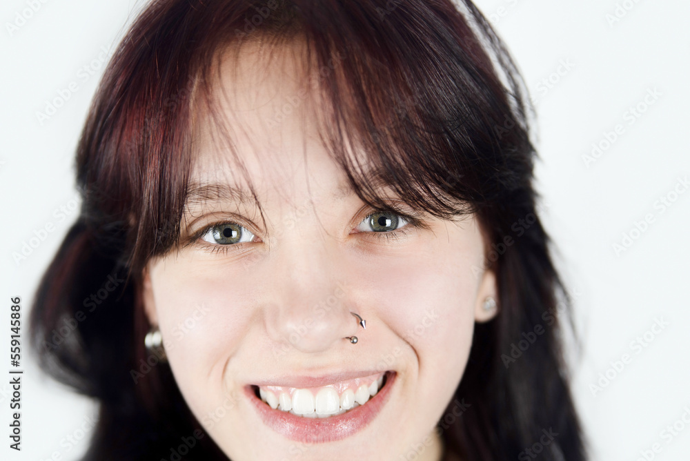 Happy teenage girl smiling beautifully close up, the girl has beautiful eyes, white healthy teeth, dark hair with a red tint. A teenage girl smiles and rejoices in her healthy life Happy teenage girl smiling beautifully close up, the girl has beautiful eyes, white healthy teeth, dark hair with a red tint. A teenage girl smiles and rejoices in her healthy life