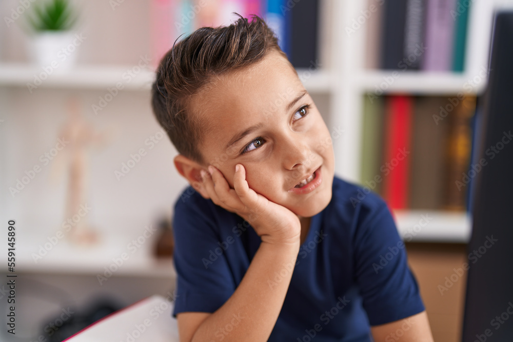 Adorable hispanic toddler smiling confident sitting on table at library school Adorable hispanic toddler smiling confident sitting on table at library school