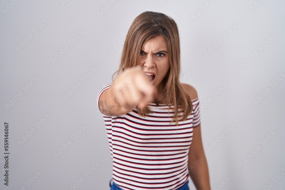 Young hispanic woman standing over isolated background pointing displeased and frustrated to the camera, angry and furious with you Young hispanic woman standing over isolated background pointing displeased and frustrated to the camera, angry and furious with you