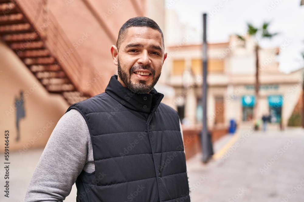Young latin man smiling confident standing at street Young latin man smiling confident standing at street