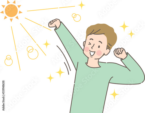 太陽の光を浴びながら伸びをする若い男性
