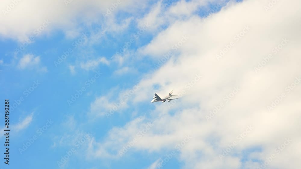 A plane flying over London city center just below the clouds, United Kingdom. A plane flying over London city center just below the clouds, United Kingdom.