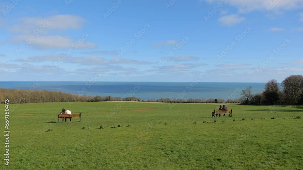 People Sitting On Benches With Ocean View In Front People Sitting On Benches With Ocean View In Front