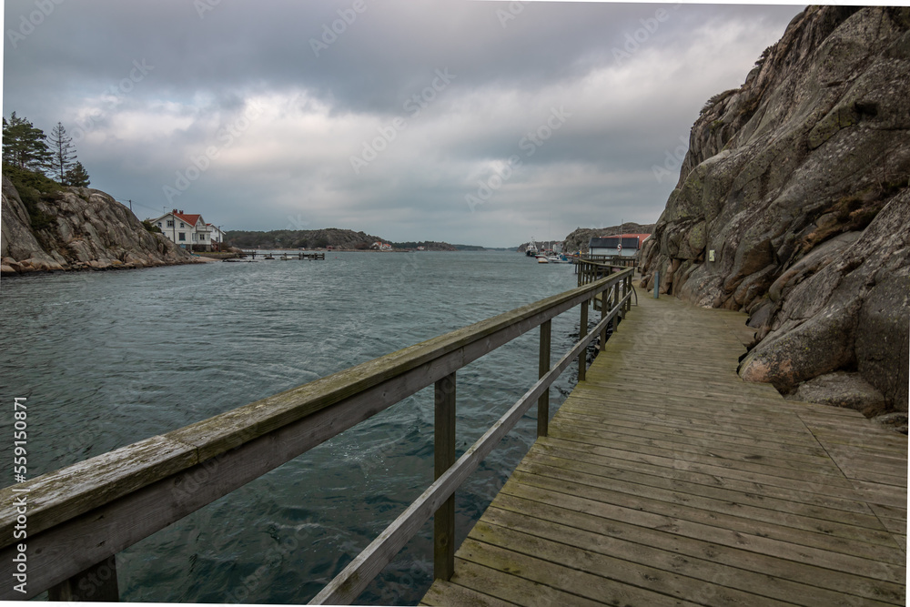 Beautiful little typical red swedish house in a long exposure directly at the sea. PORT in a bay by the sea Beautiful little typical red swedish house in a long exposure directly at the sea. PORT in a bay by the sea