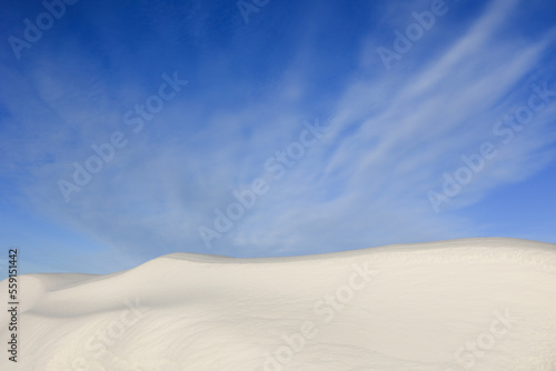 Large snowdrift with blue sky background.