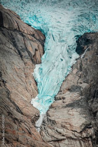 Briksdalsbreen glacier in the mountains of Jostedalsbreen national park in Norway, blue ice melting in summer