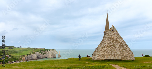 Etretat, Normandy, France - Rear view of the Notre Dame de la Garde Chapel with the Falaise d'Aval in the background - Ocean view, Aerial view