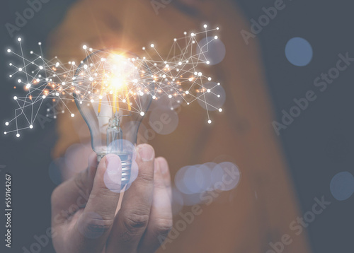 Businessman holding lightbulb on hand with technology network internet digital. Creativity innovation new technology and new ideas for business in the future.