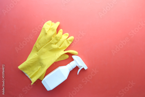 window cleaning spray, brush and gloves on purple background 