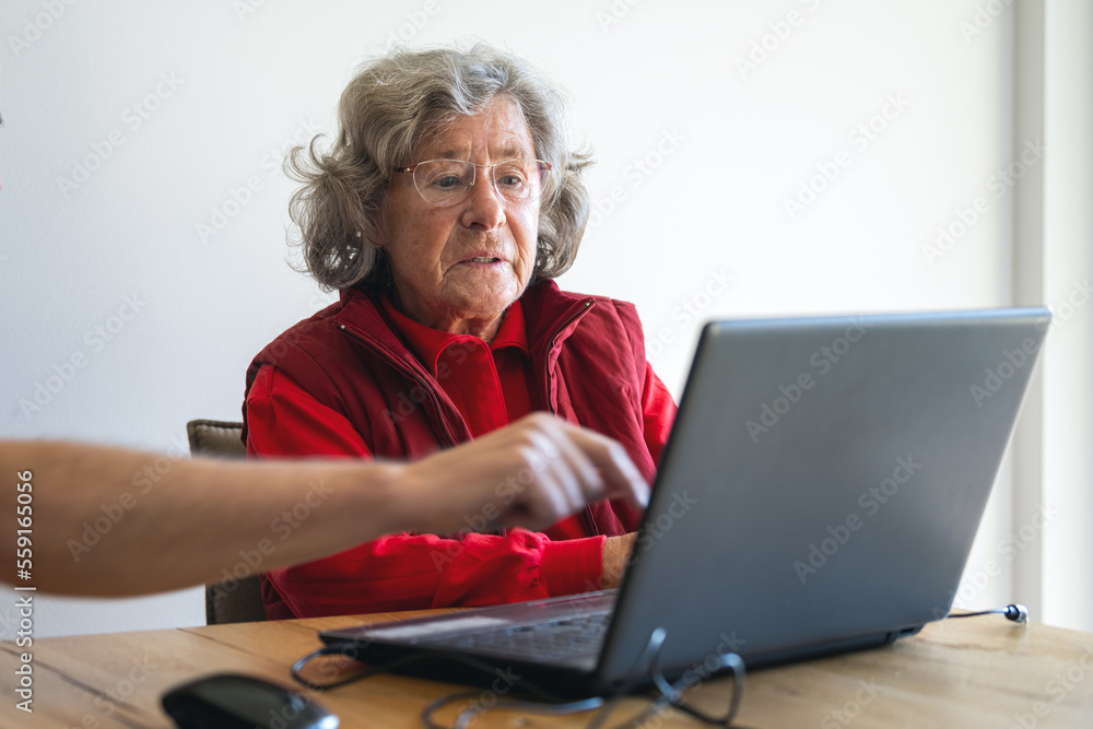 Elderly lady getting teached how to use laptop and internet Elderly lady getting teached how to use laptop and internet