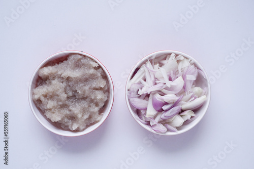 top view of slice of onion and paste in a bowl on white background 