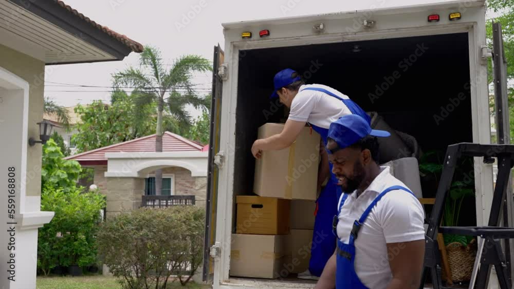 moving company employee is unloading things from a truck to bring into a new home.
moving company employee is unloading things from a truck to bring into a new home.