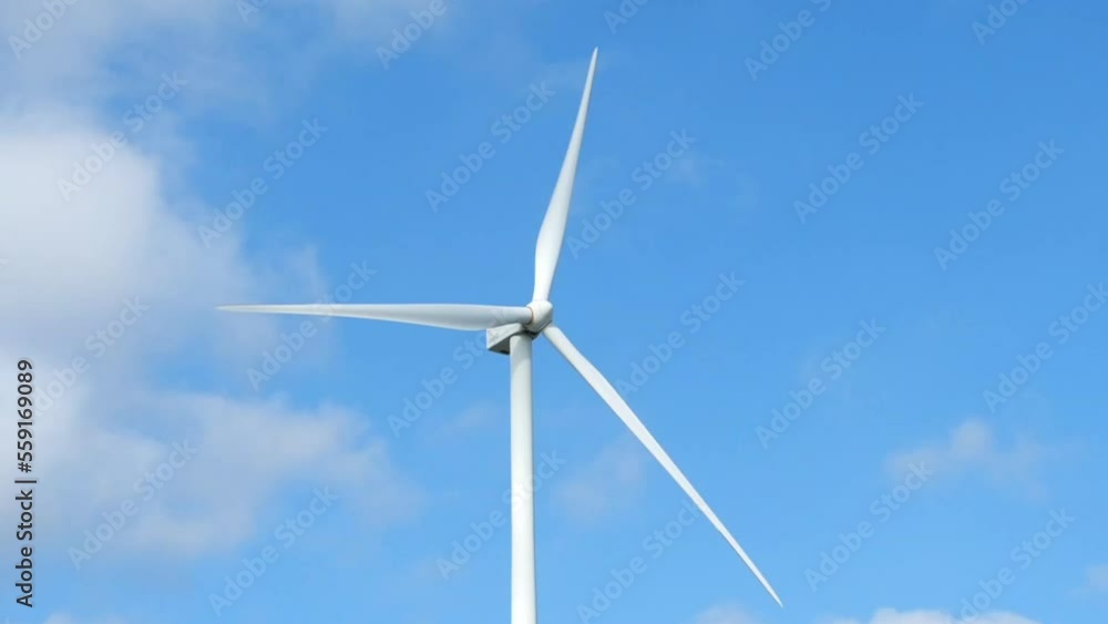 Time Lapse of Powerful Wind turbine farm for pure energy production on Beautiful clear blue sky with white clouds and wind turbine farm reflection on lake. renewable energy. Hyperlapse View Time Lapse of Powerful Wind turbine farm for pure energy production on Beautiful clear blue sky with white clouds and wind turbine farm reflection on lake. renewable energy. Hyperlapse View